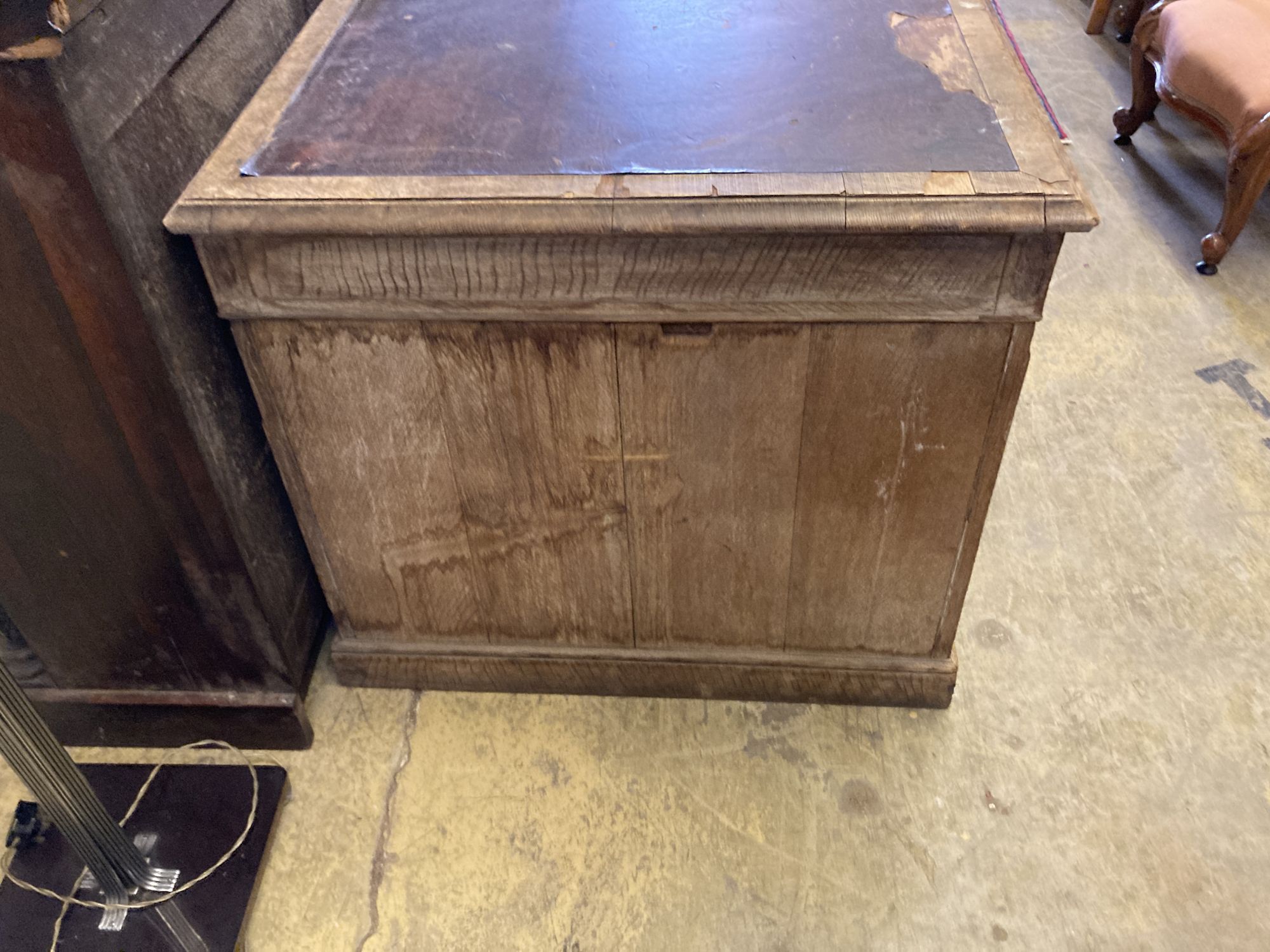 An early 20th century limed oak pedestal desk